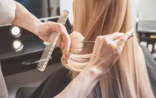 A diverse family, including children and adults, enjoys haircuts in a bright, welcoming salon environment.