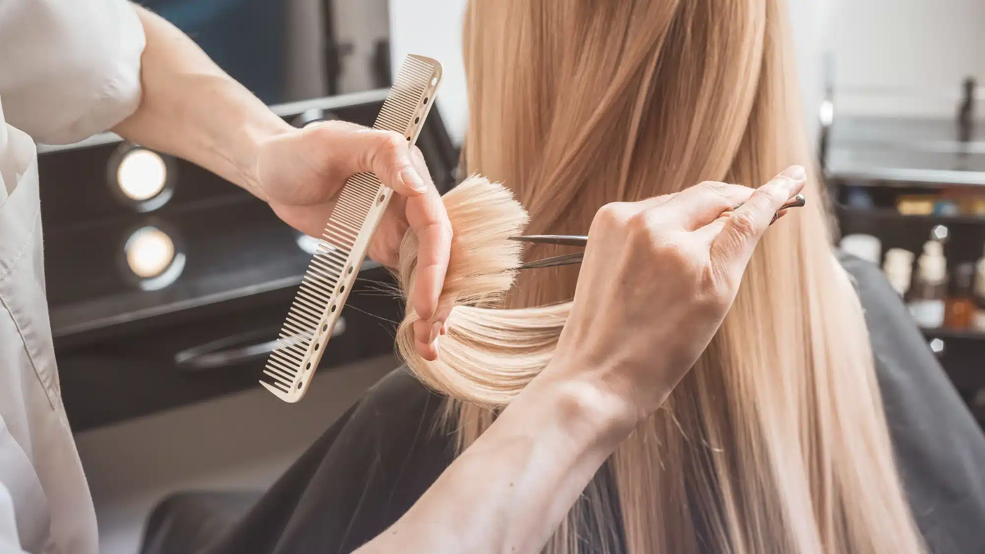 A diverse family, including children and adults, enjoys haircuts in a bright, welcoming salon environment.