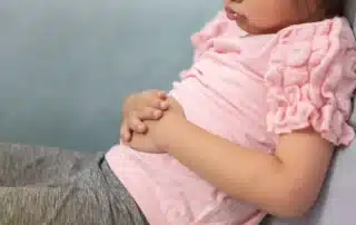 Pediatric gastroenterologist consulting with a child and parent about digestive health and gastrointestinal conditions
