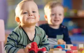 Happy baby playing with toys in a safe environment