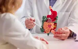 A compassionate doctor consults with parents about their child's chronic constipation in Gainesville, GA.