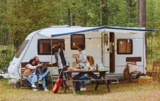 A scenic view of an RV camping site in Bozrah CT surrounded by lush greenery.
