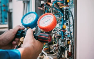 Technician performing air conditioner repair in Chester NY to prevent refrigerant leaks