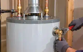 Certified technician performing water heater repair in CT home